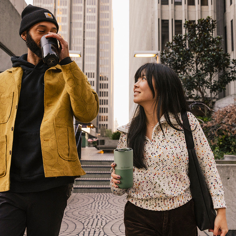 16oz-rise-tumbler-i2 16oz_rise_tumbler_black_iceberg_couple_drink_city_street_square.jpg