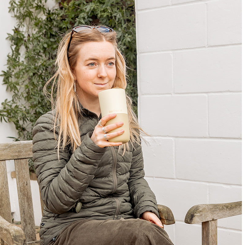 16oz-rise-tumbler-i2 16oz_rise_tumbler_wax_yellow_woman_seat_outside_square.jpg